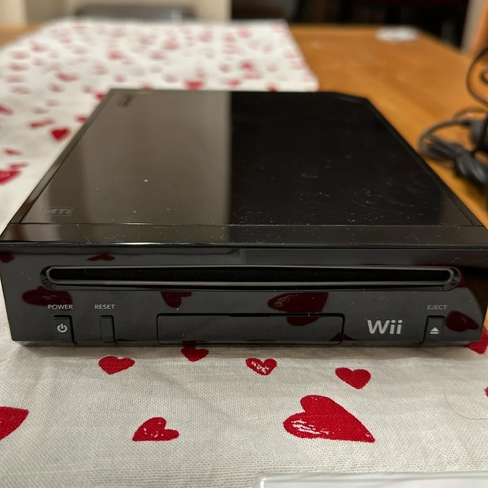 Nintendo Wii black w 2 remotes and 7 games.6 games in cases 1 has no case.